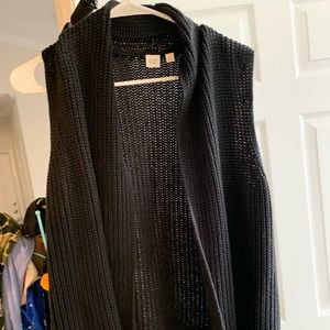 Black sleeveless cardigan.